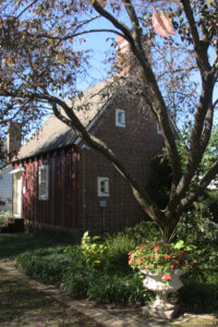 An exterior shot of Joseph's Cottage, a brown building located in our gardens.